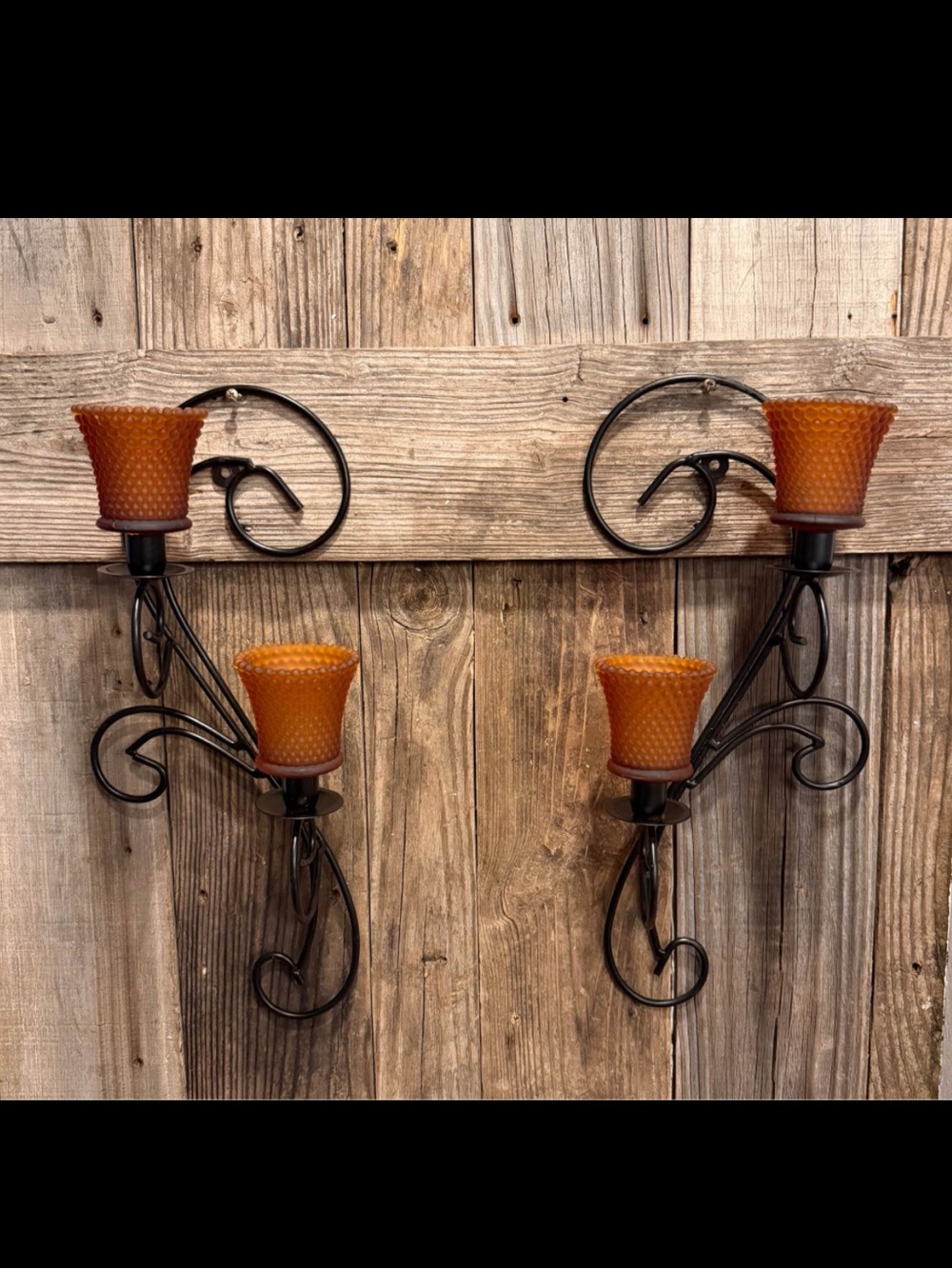 Pair of double wall sconces black scrolled metal vintage frosted amber glass